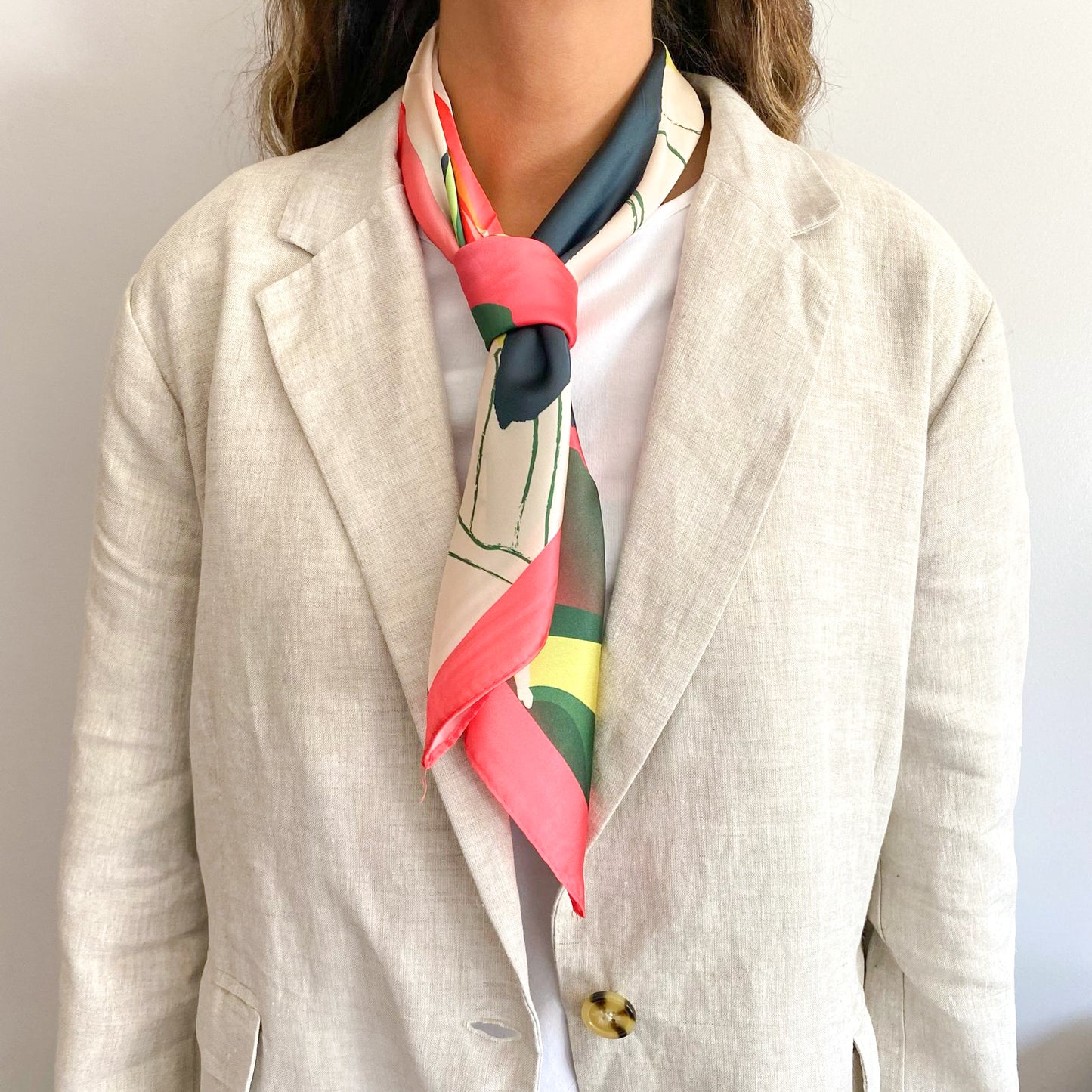 Mujer usando el pañuelo simil de seda azzurra amarrado al cuello