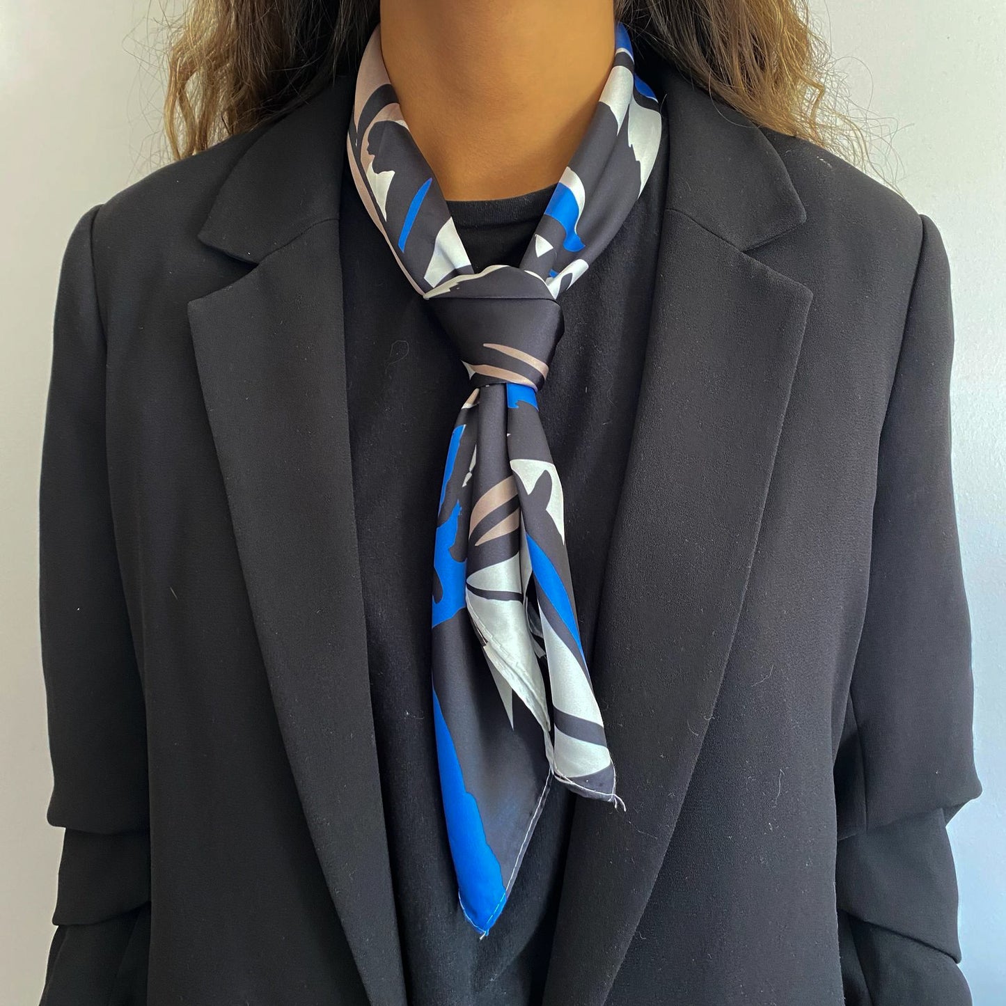 Mujer usando el pañuelo simil de seda tivoli amarrado al cuello