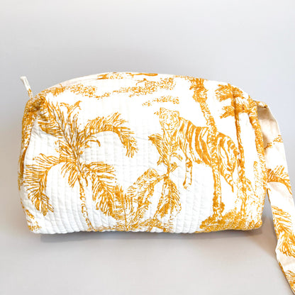 Estuche Anémona con estampado tropical en tonos dorados sobre fondo blanco.